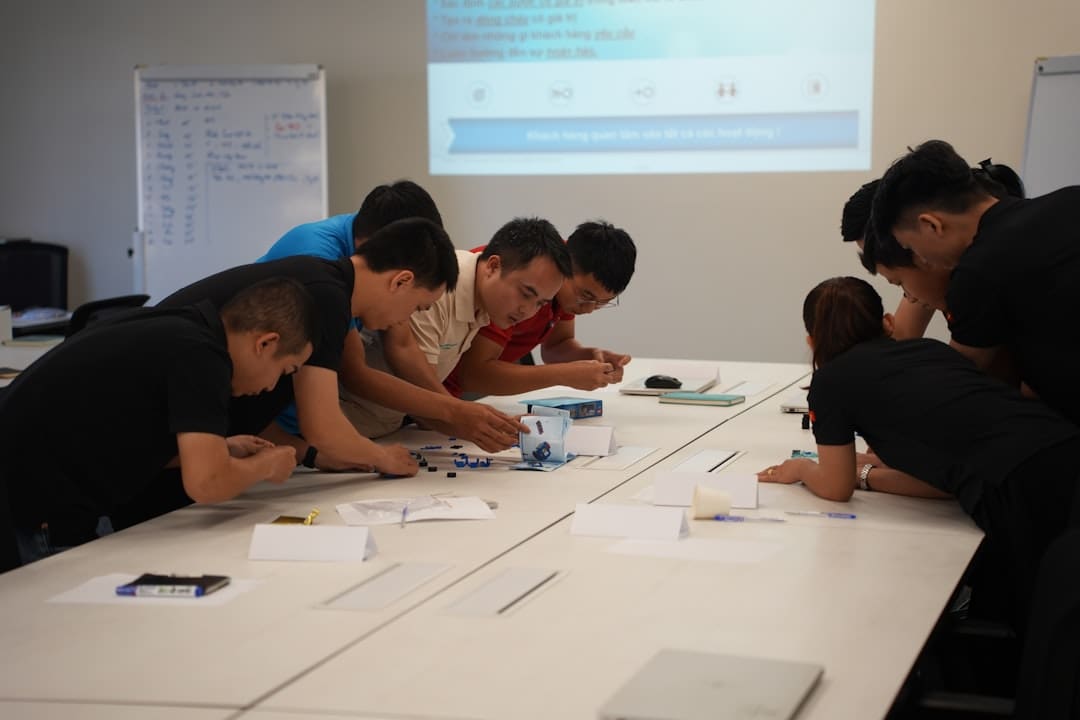 incident documentation — Team collaborating on a project at a table.