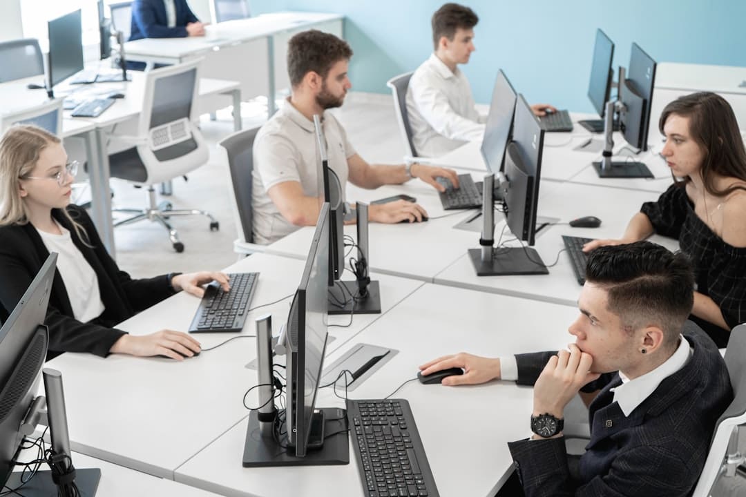 service dog policy — a group of people sitting at a table with computers