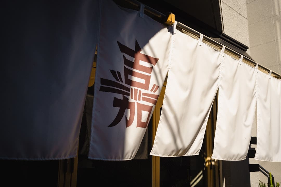 retail employee — White banners with japanese characters hang outside.