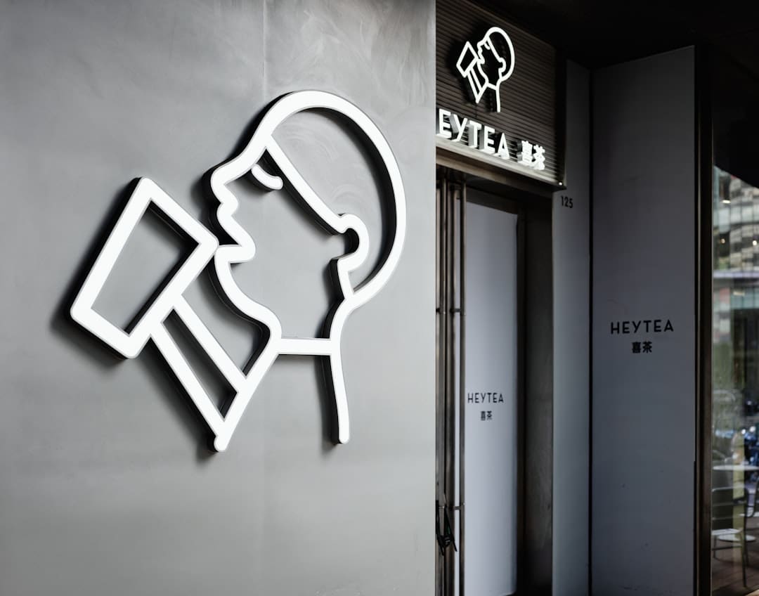 service dog access — White outline of person drinking from cup on gray wall.