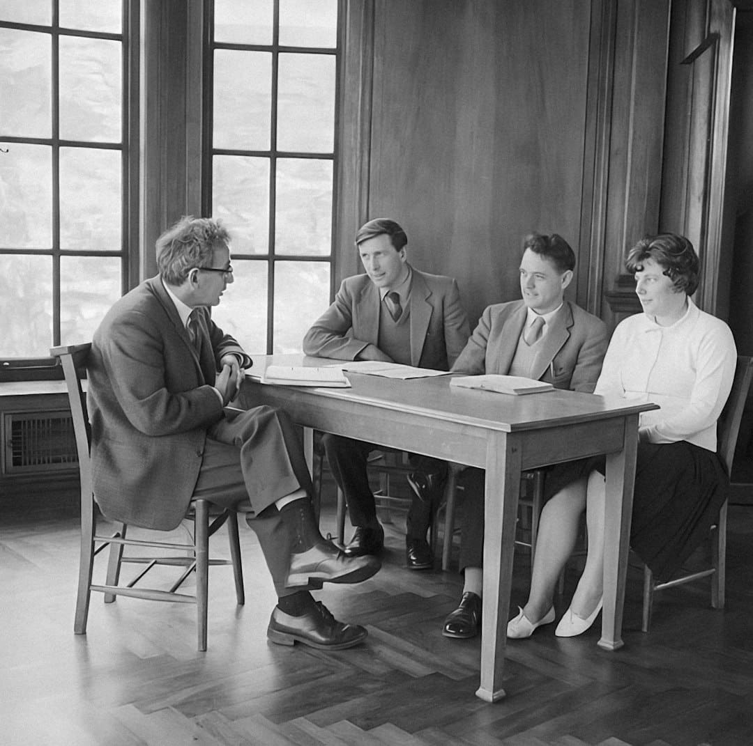 service dog access — a group of people sitting around a wooden table