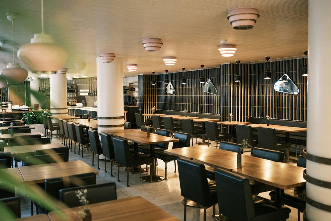 service dog access — Empty modern restaurant interior with tables and chairs